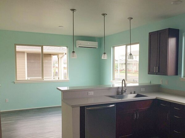 Open concept kitchen with sea foam green walls