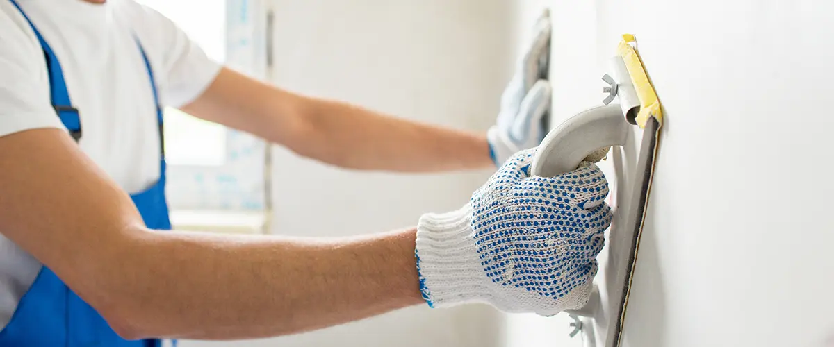 sanding wall paint using a grinding tool