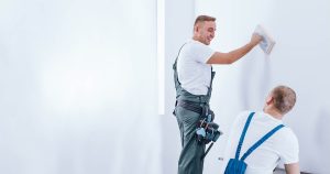 Home renovation crew preparing wall. Learn How To Prepare Interior Walls For Painting