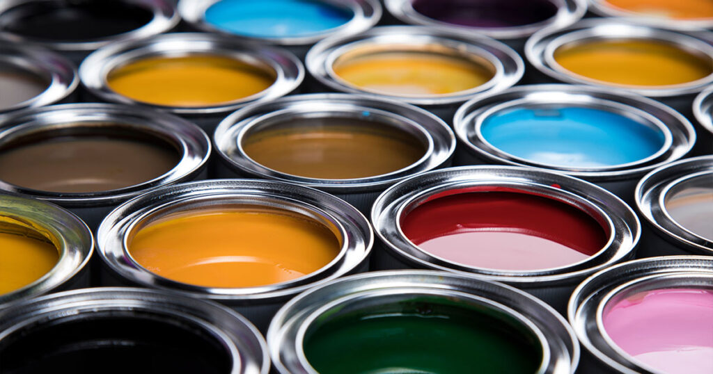 Open cans of paint, showcasing a variety of vibrant colors.