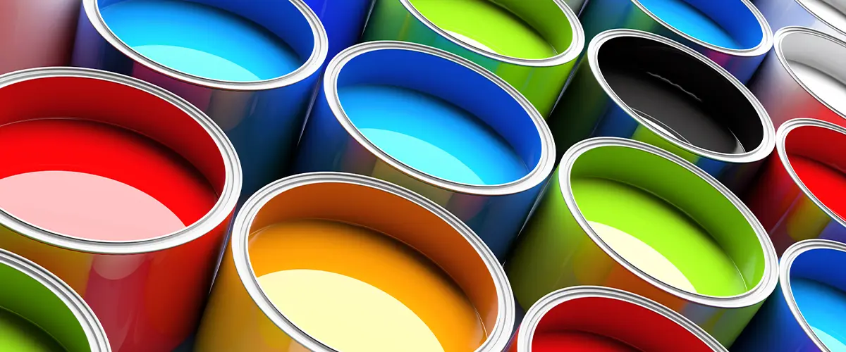 Close-up of a paintbrush dripping varnish over a can. The Difference Between Lacquer And Paint.