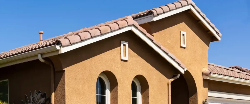 Bamboo, Lava Rock & Stucco: Painting Hawaii’s Unique Home Exteriors 2 Stucco home with arched windows and terracotta roof
