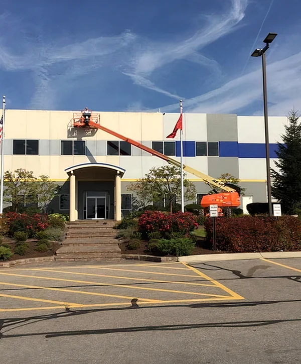 commercial painting pearl city hi professional contractors using aerial lift for commercial building exterior painting